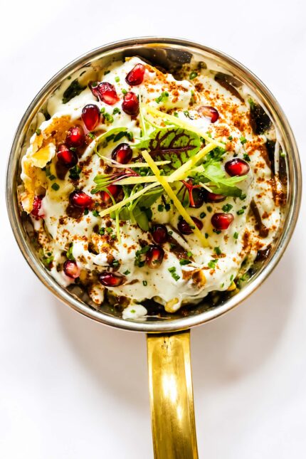 Gourmet street food chaat topped with fresh yogurt and pomegranate at Panas London.