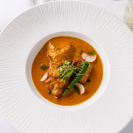 Gourmet signature chicken or paneer masala entrée featured on the Panas Restaurant menu.
