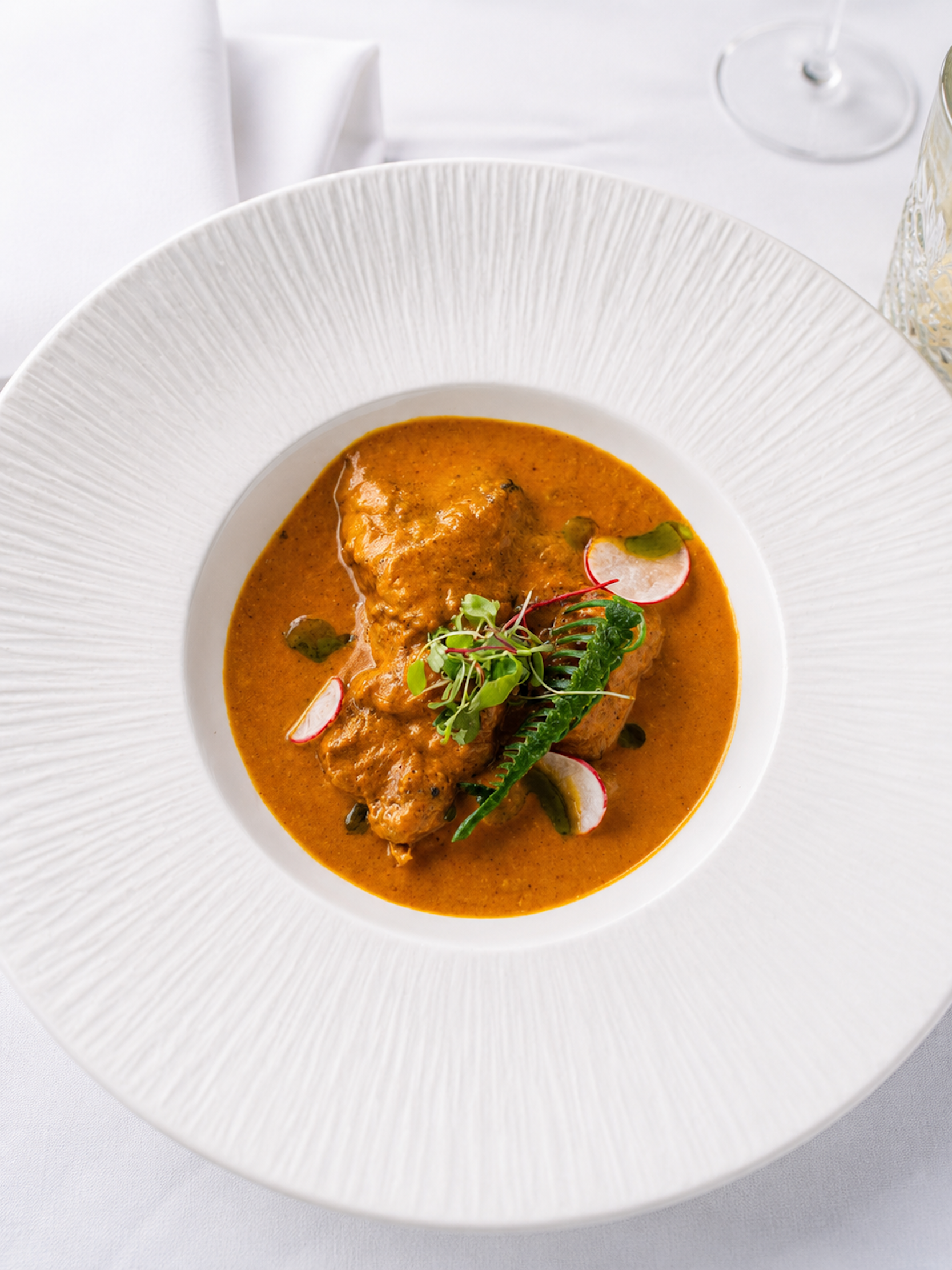 Gourmet signature chicken or paneer masala entrée featured on the Panas Restaurant menu.