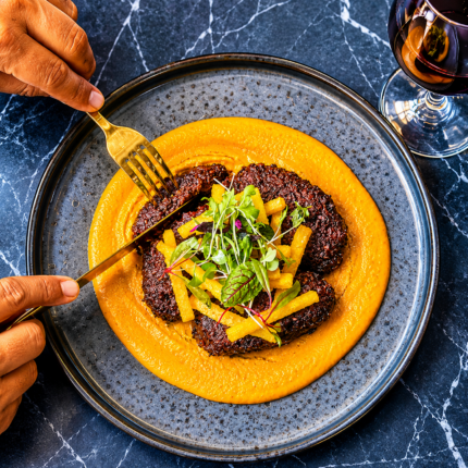 Artfully plated gourmet signature main course at Panas Restaurant.