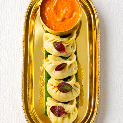 Authentic steamed Nepalese momo dumplings featured on the Panas Restaurant appetizer menu.
