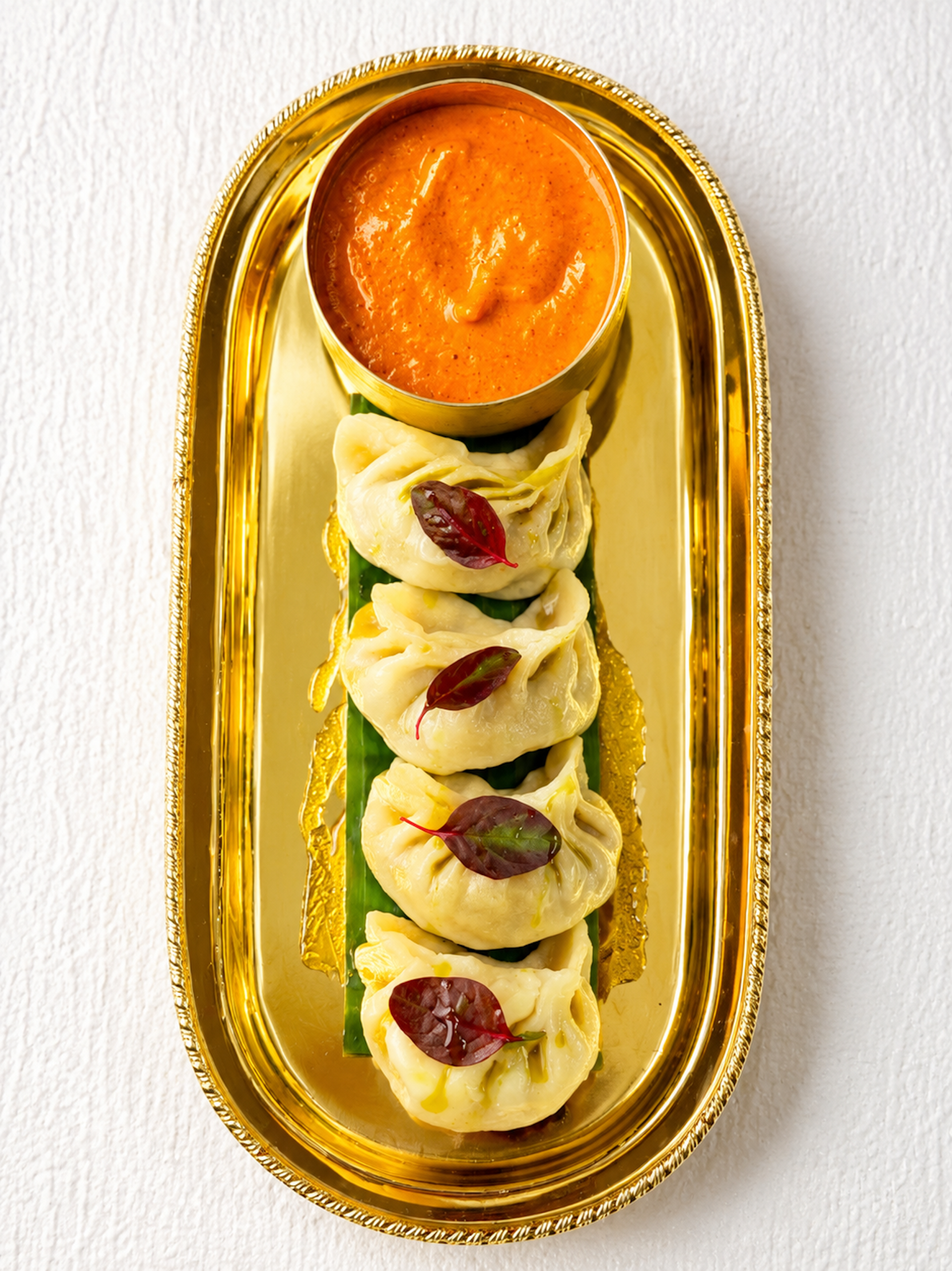 Authentic steamed Nepalese momo dumplings featured on the Panas Restaurant appetizer menu.